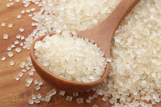 istock Wooden spoon and sugar on wooden table 1179132358