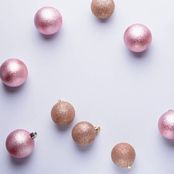 istock Creative Christmas frame with golden balls and pink ornaments on grey, copy space, minimalistic chaotic composition 1179135820