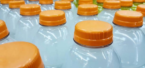 Plastic bottles of sports drinks lined up in rows.