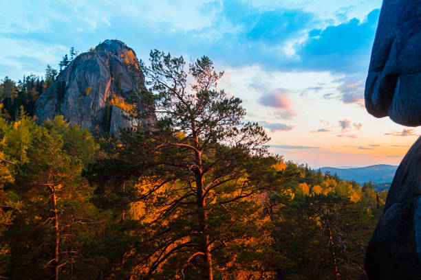 Evening mountain landscape. Mountains rocks trees against the setting sun. Krasnoyarsk National Park Pillars. Evening mountain landscape. Mountains rocks trees against the setting sun. Krasnoyarsk National Park Reserve Pillars. krasnoyarsk krai photos stock pictures, royalty-free photos & images