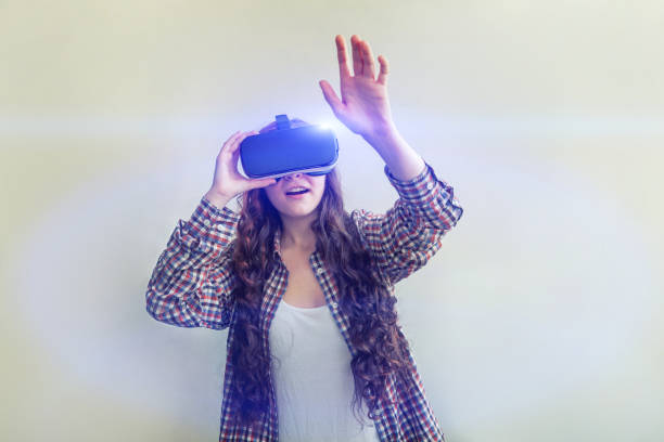istock Smile young woman wearing using virtual reality VR glasses helmet headset on white background. Smartphone using with virtual reality goggles 1179139709