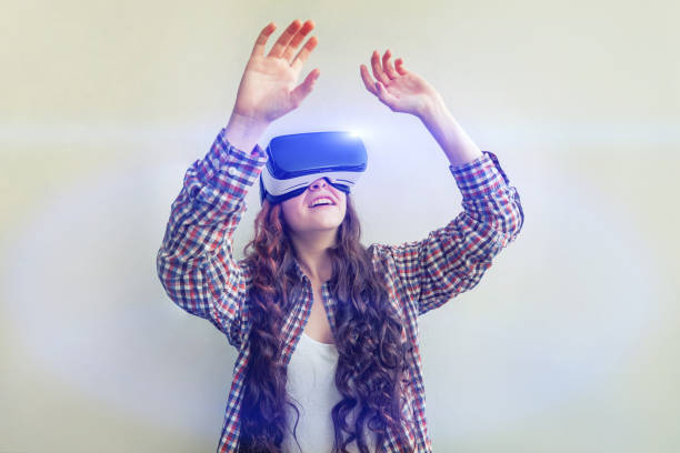 istock Smile young woman wearing using virtual reality VR glasses helmet headset on white background. Smartphone using with virtual reality goggles 1179139743