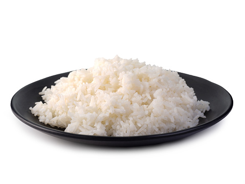 Rice in black plate on white background.