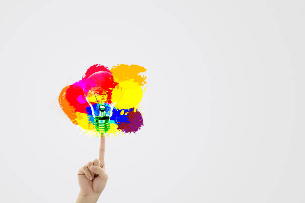 Business Idea Concept : Fingertip touch colorful light bulb with grey background.