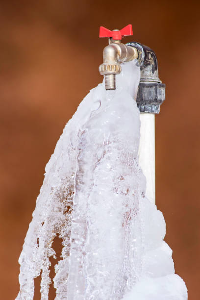 Frozen faucet in winter. Brown background faucet frozen water stock pictures, royalty-free photos & images
