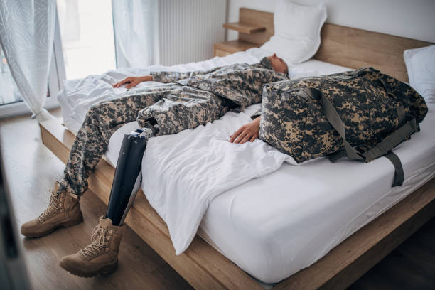 istock Depressed soldier with amputee leg  in the bedroom 1179146227