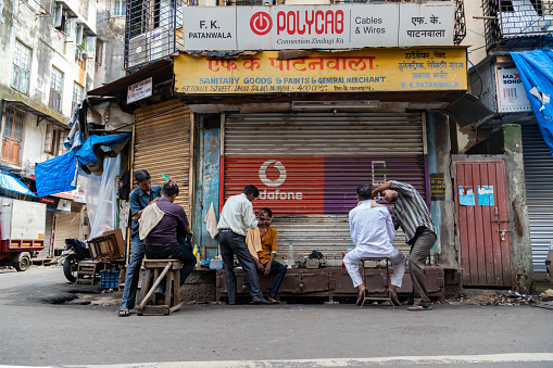 A street barbershop on the backstreet of Fort Market Near Queen Victoria Station. It not only offers quick and cheap haircuts and shavings, but also functions as a community center.