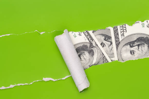 istock US money through ragged paper 1179146292