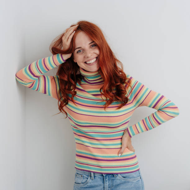 istock Relaxed vivacious young woman leaning on a wall 1179149001