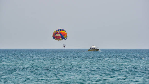 istock Parasailing towing a parachute boat with a man 1179149179