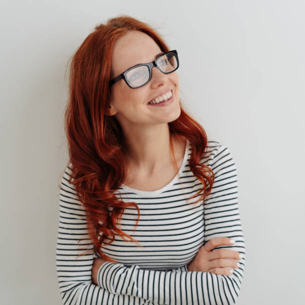 istock Happy young woman standing deep in thought 1179150366