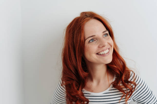 istock Vibrant happy young woman standing thinking 1179150494
