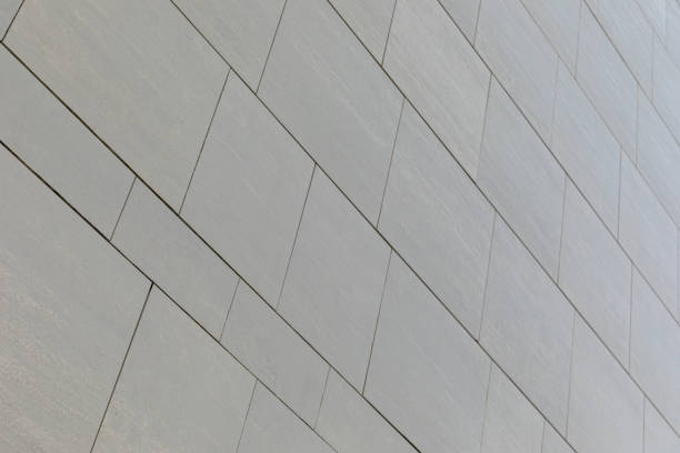 istock Low angle view of wall with gray smooth tiles of different shape (rectangular and square). 1179150574