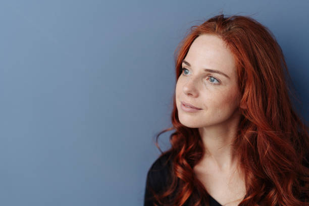 istock Thoughtful young redhead woman looking aside 1179150662