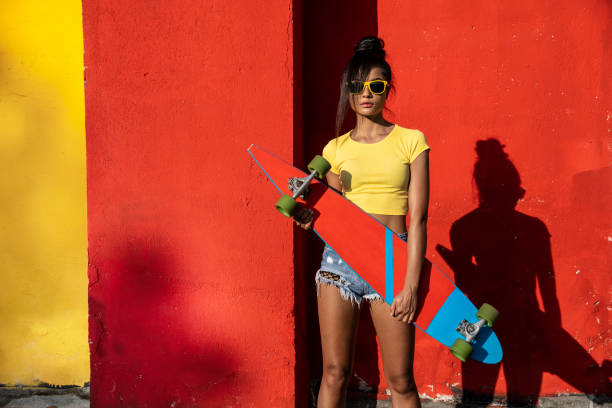 istock Woman holding scateboard 1179151546