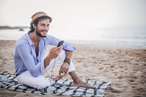 istock Guy text messaging an listening to music 1179153772