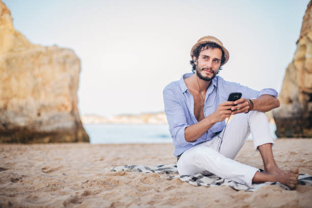istock Fashionable young man on the beach 1179153784