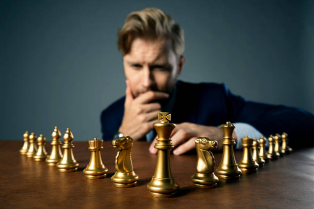 istock businessman with chess figure setup on dark background . Leadership and strategy ideas concept for success achievement . business organization concept 1179153910
