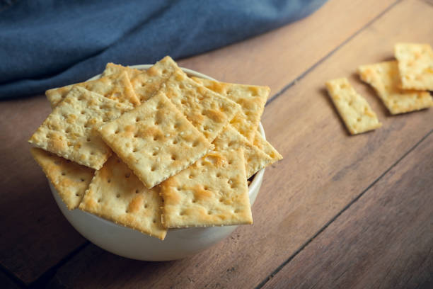 Crispy crackers with sesame in bowl Crispy crackers with sesame in bowl Saltine Crackers stock pictures, royalty-free photos & images