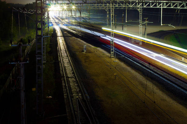 istock The train rushes along the rails at night 1179154451