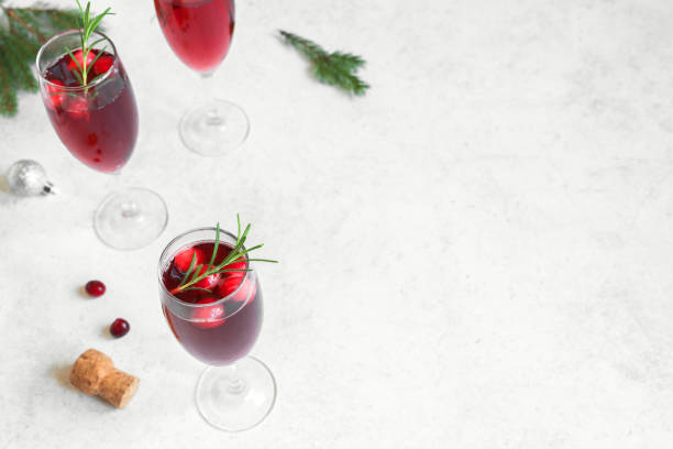 Christmas cranberry mimosa Christmas red cranberry mimosa with rosemary on white background, copy space. Cocktail with champagne for Christmas morning. rose christmas red white stock pictures, royalty-free photos & images
