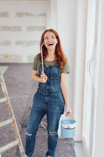 istock Laughing happy young woman doing painting 1179157242
