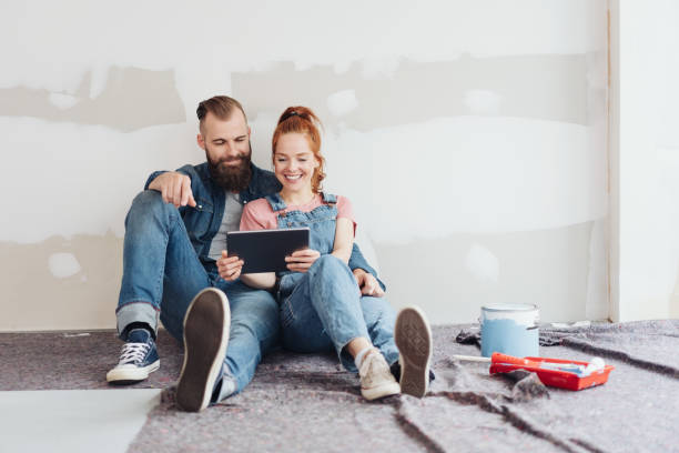 Young couple doing home renovations taking a break