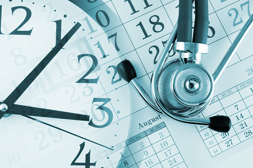 Regular medical examination concept, clock and stethoscope on calendar background