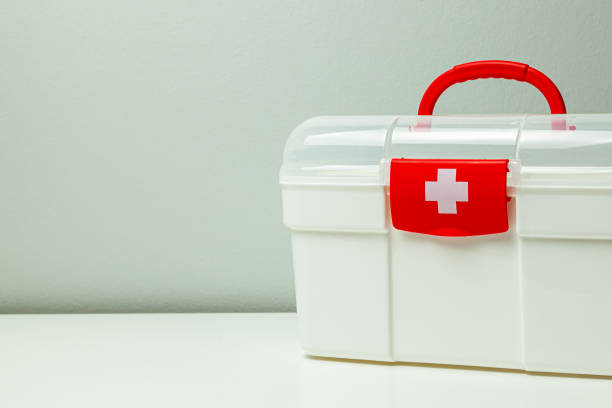istock First Aid Kit. White box with a cross and a red clasp on a gray background 1179161193