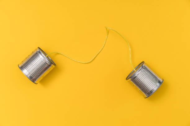 tin can phone on yellow background - telephone can communication tin can phone imagens e fotografias de stock