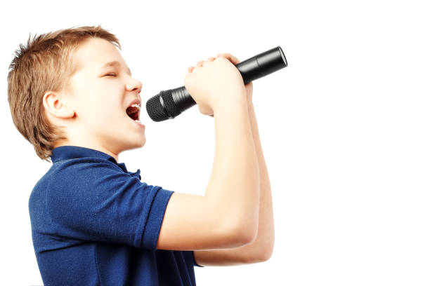 istock Teenage boy singing into a microphone. Very emotional. 1179162304