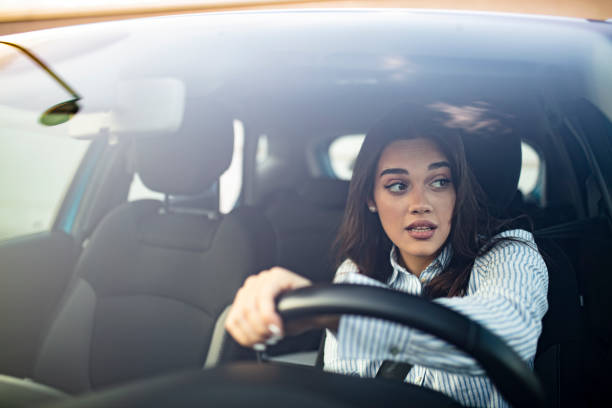 istock Young woman driving her car. 1179162360