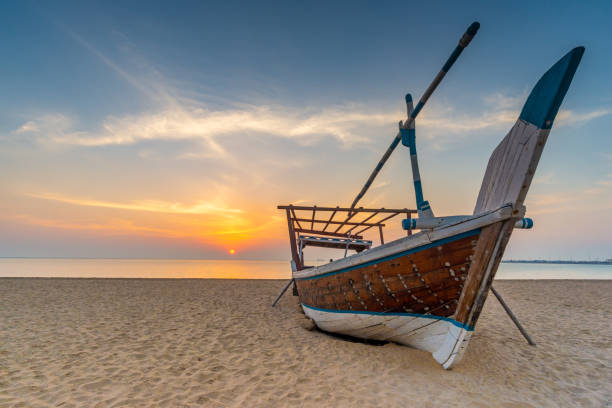 Traditional Arabian boat on a beach, Wakrah, Qatar Traditional Arabian boat on a beach. Taken early morning on a beach near Al Wakrah, Qatar dhow photos stock pictures, royalty-free photos & images