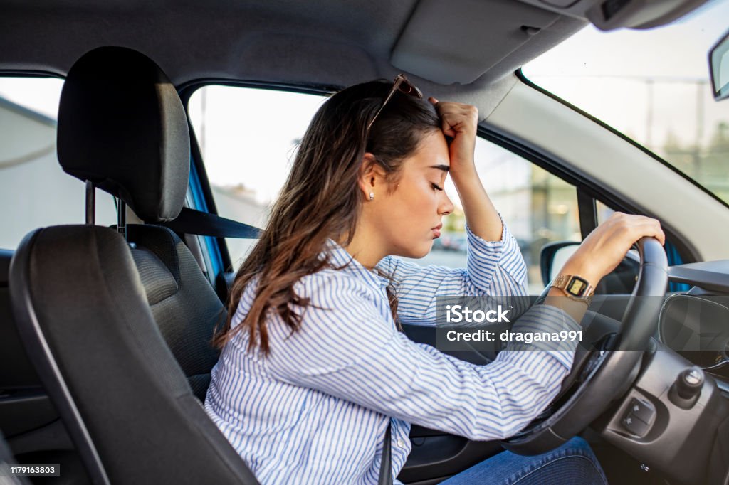 Stressed woman drive car feeling sad and angry. Stressed woman drive car feeling sad and angry. Girl tired, fatigue mental on car. Sleepy and drunk female hangover. Illegal law driver license. Driving when tired and do not drive drowsy concept Car Stock Photo