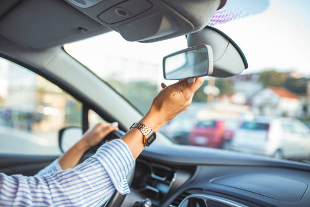 istock Beautiful female Driver adjusting the Rear Mirror. 1179165166
