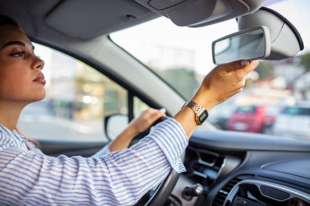 istock Girl adjusts the rear view mirror. 1179165219