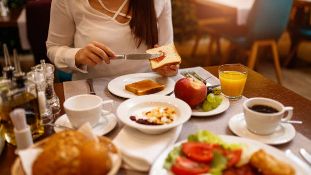 istock Young woman spreading jam on a toast 1179165359
