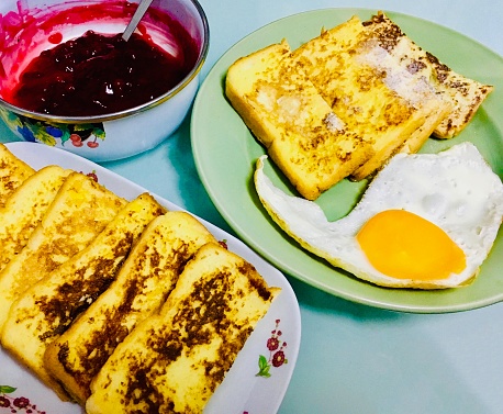 Breakfast French Toast with Fried Egg and Cranberry Sauce. A Dish Made of Sliced Bread Soaked in Eggs and Milk Then Fried.