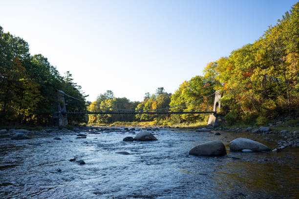 The Wire Bridge over the Carrabassett River This view of the Wire Bridge in New Portland, Maine was made on October 5, 2019, during peak foliage season. carrabassett stock pictures, royalty-free photos & images