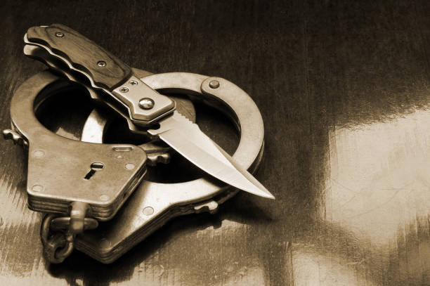 istock Steel metallic handcuffs and knife 1179169376