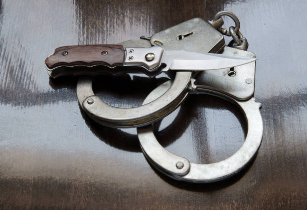 istock Steel metallic handcuffs and knife 1179169398