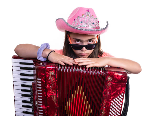 Young preteen girl  with accordion isolated on a white background.