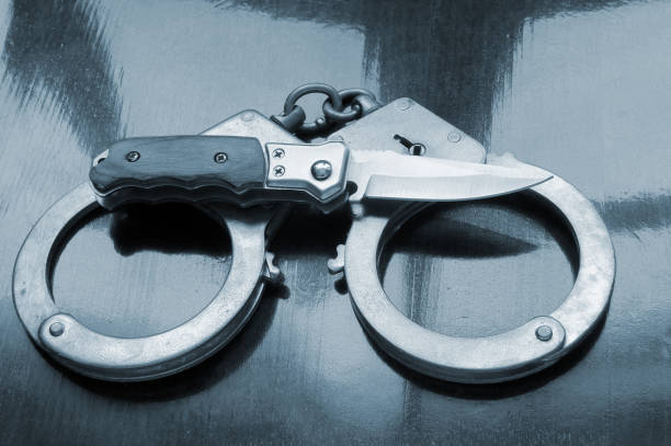 istock Steel metallic handcuffs and knife 1179169443