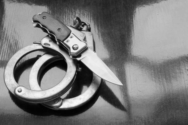 istock Steel metallic handcuffs and knife 1179169488