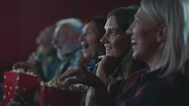 Smiling woman watching movie at cinema