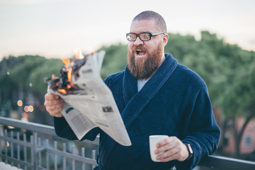 Picture of bearded man reading newspaper