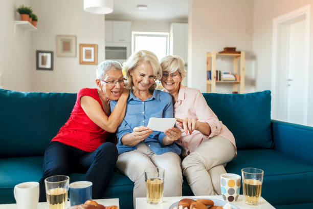 istock Group of happy elderly people looking at photos 1179171100