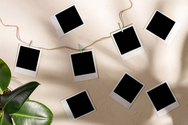 istock Blank photos hang with clothespins on a textural background. 1179172117