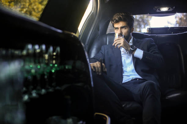 istock CEO drinking whiskey in a limousine 1179176394