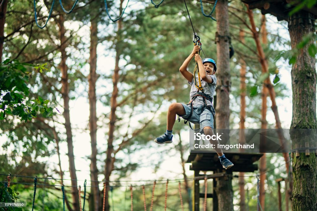 Little boy ziplining in forest Little boy practicing in ropes course in adventure park. The boy is ziplining on sunny summer day.
Nikon D850 Zip Line Stock Photo